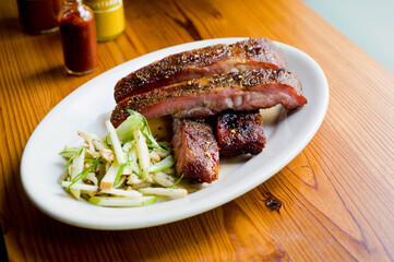 Pork ribs, barbecue style. Classic Traditional Texas Smokehouse favorite menu item: Baby Back pork ribs. Slow cooked in seasoned smoker over mesquite wood chips covered in homemade bbq sauce. 