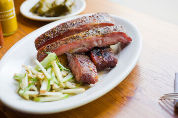 Pork ribs, barbecue style. Classic Traditional Texas Smokehouse favorite menu item: Baby Back pork ribs. Slow cooked in seasoned smoker over mesquite wood chips covered in homemade bbq sauce. 