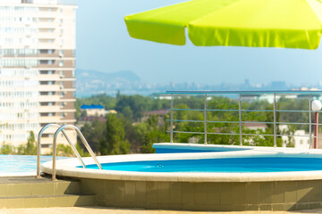 Outdoor swimming pool on beautiful cityscape background