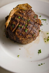 Steaks. Grade A grass fed angus beef steaks. Tenderloin, filet mignon, New York strip, bone in rib-eye grilled medium rare on outdoor wood-fired grill. Classic American steakhouse entree favorite.