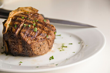 Steaks. Grade A grass fed angus beef steaks. Tenderloin, filet mignon, New York strip, bone in rib-eye grilled medium rare on outdoor wood-fired grill. Classic American steakhouse entree favorite.