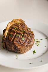 Steaks. Grade A grass fed angus beef steaks. Tenderloin, filet mignon, New York strip, bone in rib-eye grilled medium rare on outdoor wood-fired grill. Classic American steakhouse entree favorite.