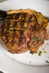 Steaks. Grade A grass fed angus beef steaks. Tenderloin, filet mignon, New York strip, bone in rib-eye grilled medium rare on outdoor wood-fired grill. Classic American steakhouse entree favorite.