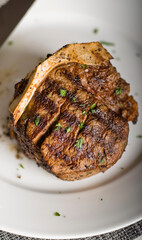 Steaks. Grade A grass fed angus beef steaks. Tenderloin, filet mignon, New York strip, bone in rib-eye grilled medium rare on outdoor wood-fired grill. Classic American steakhouse entree favorite.