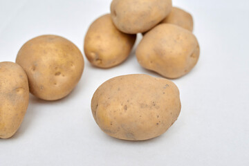 fresh unpeeled potatoes on a white background