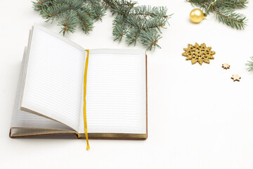 New Year's white background. Notebook for writing, fir branches, snowflakes, golden balls