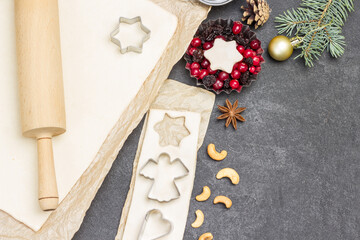 Preparing Christmas treat. Rolling pin for dough. Cookie cutter molds. Metal form with berries and...