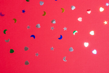 shiny confetti on matte red background