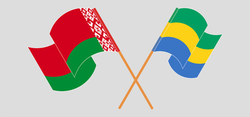 Crossed and waving flags of Belarus and Gabon