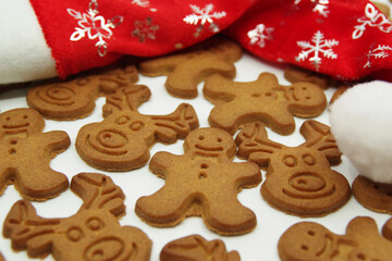 Christmas gingerbread cookies and Santa Claus red hat isolated on a white background. Closeup