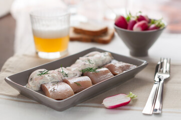 Fototapeta na wymiar Pickled Herring with Sour Cream and Onion. Glass of Beer