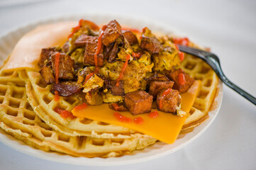 Chicken and waffles. Classic American Diner Style Breakfast or Brunch menu item favorite. Crispy homemade fried chicken on top of home buttermilk waffles topped with butter and maple syrup. 