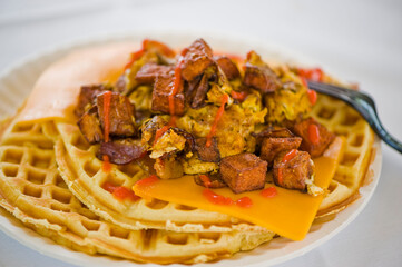 Chicken and waffles. Classic American Diner Style Breakfast or Brunch menu item favorite. Crispy homemade fried chicken on top of home buttermilk waffles topped with butter and maple syrup. 