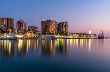 Naklejka premium Yachts parked in Malaga Port with Cityscape and Buildings Behind
