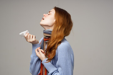 red-haired woman napkin in hand runny nose scarf sweater model