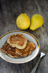 Pancakes on a plate on an oak table