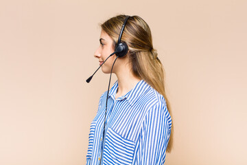 blonde pretty woman on profile view looking to copy space ahead, thinking, imagining or daydreaming