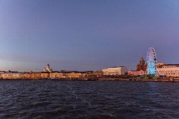 Naklejka premium Scenic night view of the Old Town architecture and pier and Lutheran Christian Cathedral Church at the Senate Square in Helsinki, Finland, panoramic Presidential house.View Of Evening City Uspenski.