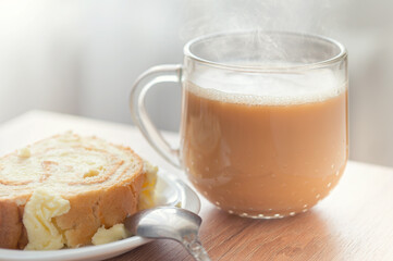 Glass cup of cocoa with biscuit roll