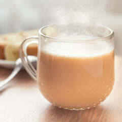 Glass cup of cocoa with biscuit roll