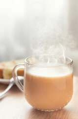 Glass cup of cocoa with biscuit roll