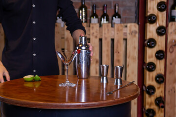 Bartender preparing colorful delicious cocktail. Barman making alcoholic drinks in bar, restaurant. Party time.