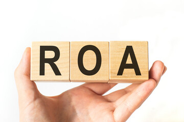 Word roa made with wood cubes, stock image. Financial concept.