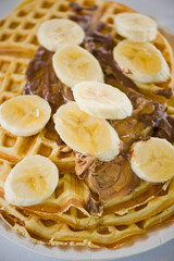 Waffles. Homemade Belgian Waffles topped with an assortment  toppings: peanut butter Nutella fresh fruits, dried fruits, chopped pistachios walnuts and almonds. 