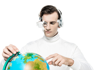 Cyborg man in eye lens and headphones pointing with finger at globe on blurred foreground isolated on white