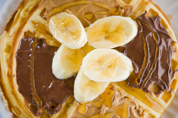 Waffles. Homemade Belgian Waffles topped with an assortment  toppings: peanut butter Nutella fresh fruits, dried fruits, chopped pistachios walnuts and almonds. 