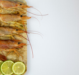 red shrimp on a wooden cutting board on a white background seeafood