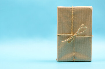 Gift box in beige packaging on a blue background