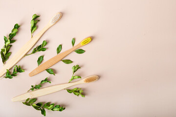 A family set of four wooden toothbrushes on white wooden background
