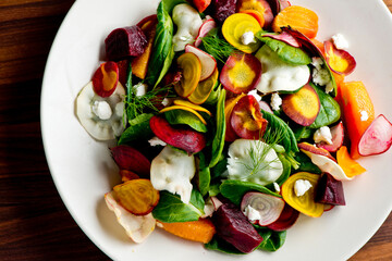 Beet salad. Classic Steakhouse salad made with organic beets, iceberg lettuce, cherry tomatoes, blue cheese dressing, carrots and Italian parsley. Traditional restaurant salad.