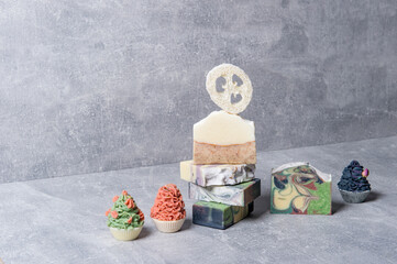 Handmade soaps and loofah sponges on grey background. Eco lifestyle concept...