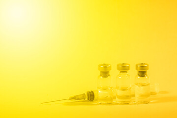 Close-up medical syringe with a vaccine. Vaccination and healtcare concept.