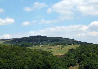 Obraz premium panoramic view across the calder valley in west yorkshire with midgley moor village and farmhouses in summer