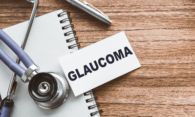 Card with the word GLAUCOMA on a wooden doctor's table.