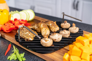 Grill rack with ready-made mushrooms and fish.