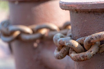 Close-up of bollards and iron chains on an old River barge. Securing the ship with a large chain. Old rusty vintage mooring bollard for boats, ships and yachts. Control system for the ferry.