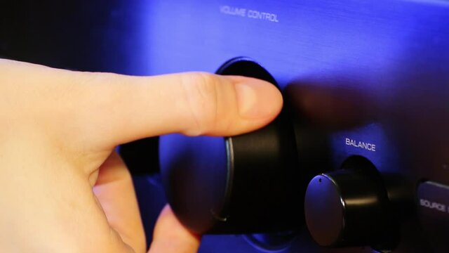 A woman's hand brings sound volume up and makes louder closeup