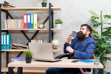 A morning coffee is my favorite way of starting the day. Businessman drink tea at office desk....