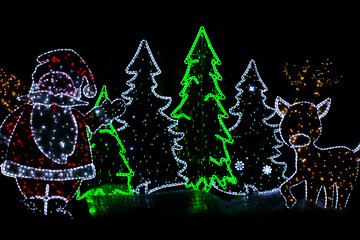 Christmas decorations isolated on black background. Santa, tree and animal ornaments. 