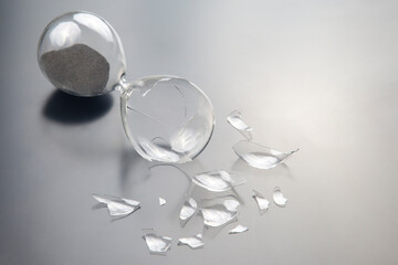 broken hourglass. waste of time. end of opportunity. stop measuring hours. shards of glass. shattered hope.