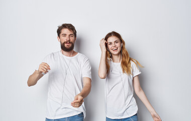 young couple in white t-shirts and jeans fun lifestyle isolated background