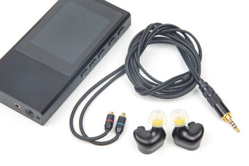 In-ear headphones for Hi-Fi music player. Audio sound and modern equipment for music lovers and audiophiles