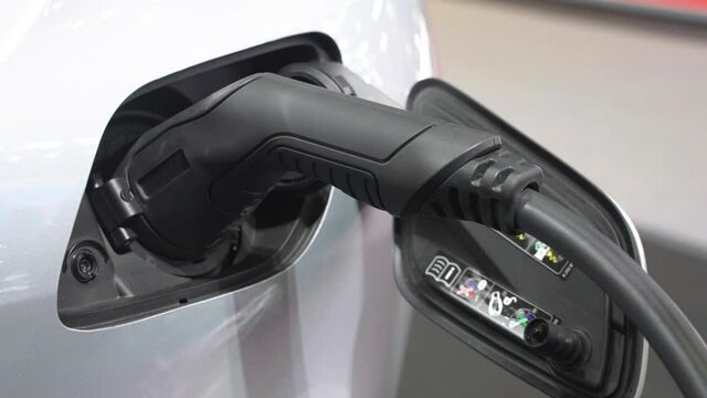 Electric vehicle charging port plugging in EV modern car. save ecology alternative energy sustainable of future