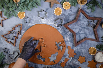 The process of making cookies and gingerbread at home. Rolled dough with carved Christmas pattern view from above