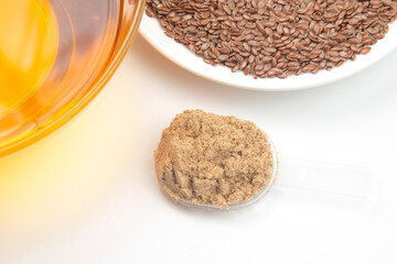 ground flaxseed and oil on a white background. vitamins and healthy food