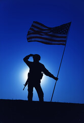 Silhouette of American army soldier, Marines rifleman saluting and holding waving on wind national...